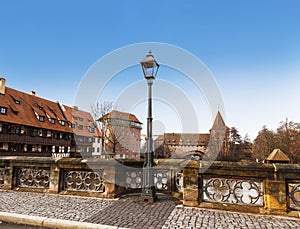 Urban landscape with a bridge over the Pegnitz river and part of the fortress wall. Nuremberg, Bavaria.