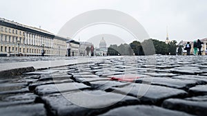 An urban landscape with cobblestones and buildings in the background. rainy day. wet paving stones