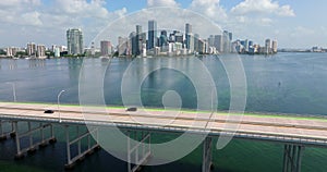 Urban landscape of downtown district of Miami Brickell in Florida with cars driving over bridge. Skyline with high