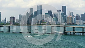 Urban landscape of downtown district of Miami Brickell in Florida with cars driving over bridge. Skyline with high