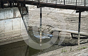 urban landscape with sewage from a pipe into a river