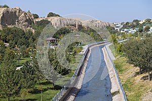 Urban landscaped park with a canal on the outskirts of Samarkand. Uzbekistan