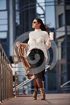 Urban life. Young beautiful girl in warm clothes have walk in the city at her weekends time