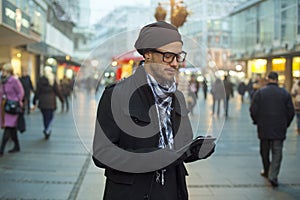 Urban man holdin tablet computer on street