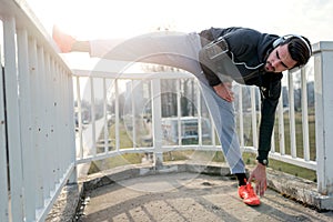 Urban Man Jogger Stretching Leg Outdoors Before Running