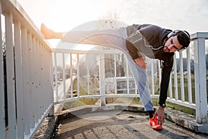 Urban Man Jogger Stretching Leg Outdoors Before Running