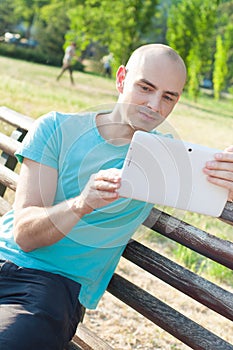 Urban man reading tablet computer