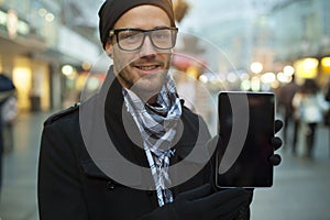 Urban man show tablet computer on street