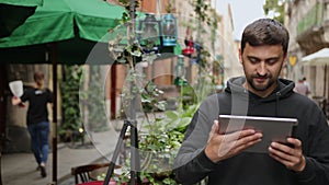 Urban man using tablet computer outside app on 5g wireless device. Casual male