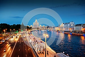 Urban night background, Moscow, the capital of Russia. Embankment in the city center, view of the river and the historic center o