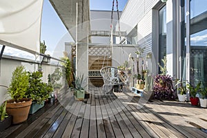 An urban one story penthouse terrace with dark wood