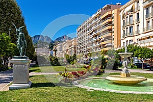 Urban park and colorful buildings in Menton, France.