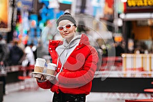 Urban portrait of young girl in New York with coffee, female in trendy sunglasses, stylish clothes