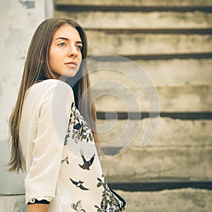 Urban portrait of young hipster girl on stairs