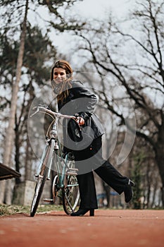 Urban professional woman enjoying a break with her bicycle in a city park