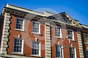 An urban red brick home in london with CCTV camera