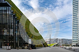 Dusseldorf - urban redevelopment. Diagonally rising walkable green roof, three-slice high-rise, modern architecture, green walls