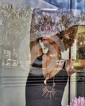 Urban reflections on a mannequin are integrated in the capture.