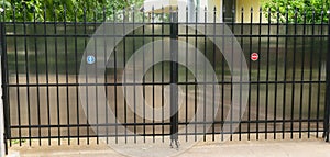 Urban residential private property car access gate made from steel tubing and polycarbonate to protect viewer discretion