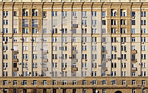 Urban residential stalinist building wall with windows front view close up