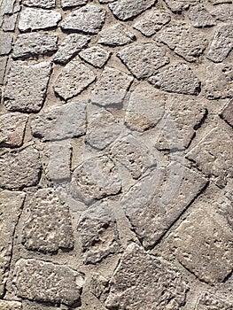 Sardinia. Traditional architecture. Urban road paved with rough ashlars of local volcanic stones. Detail photo
