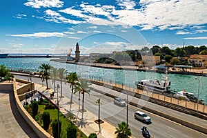 Urban road and port with lighthouse in Palma de Mallorca, Spain