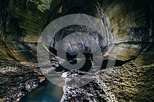 Urban sewage flowing through large oviform underground turning sewer tunnel