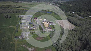 Urban sewage treatment plant. Aerial photography of sewage treatment plants located among beautiful green hilly terrain. Recycling
