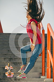 Urban skate girl with skateboard.
