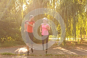 Urban sports - couple jogging for fitness in the city on a beautiful summer day