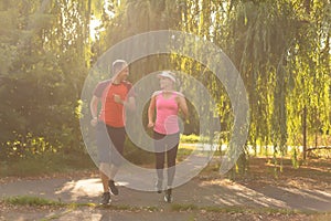 Urban sports - couple jogging for fitness in the city on a beautiful summer day