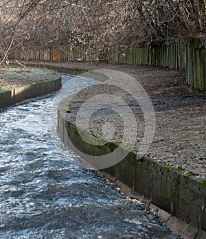 Urban stream in winter. The Lybid river