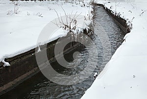 Urban stream in winter. The Lybid river