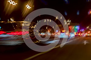 Urban street night traffic with bokeh lights. Blurred auto with bright brake lights, city street lights and speed