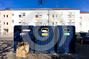 Urban sustainability: Colorful recycling bins in a city neighborhood.