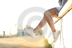 Urban teenager legs wearing sneakers