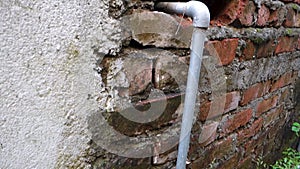 Urban Utility: Exposed GI Pipe Plumbing Fitting on Brick Wall, Dehradun City, India - Stock Media for Industrial and Architectural