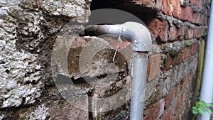 Urban Utility: Exposed GI Pipe Plumbing Fitting on Brick Wall, Dehradun City, India - Stock Media for Industrial and Architectural