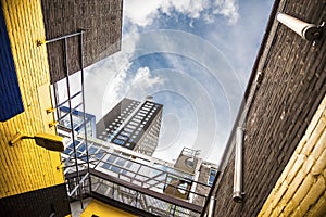 Urban view with brown and yellow walls and a skyscraper