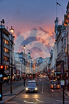 Urban view of London city near Piccadilly Circus with night traffic. Rush hour in London city against a cloudy sky at night