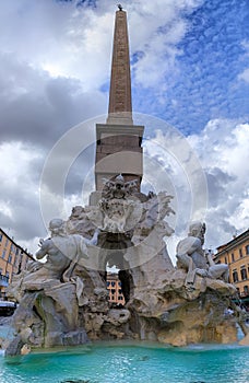 Urban view of Rome, Italy: Fountain of the Four Rivers with an Egyptian obelisk in Navon Square (Piazza Navona).