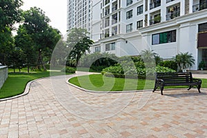 Urban walking road among green tree in modern apartment buildings in big city