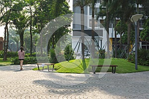 Urban walking road among green tree in modern apartment buildings in big city