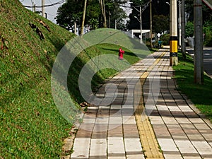 Urban walkway of tiles with a center line special accessibility for blind people