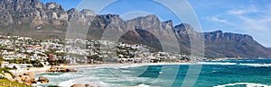 Urban waterfront town cityscape with a rocky mountain range behind in Cape Town, South Africa