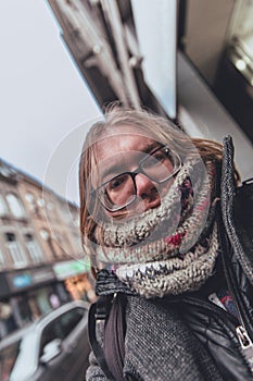 Urban Winter Style: Person with Knitted Scarf and Glasses in the City