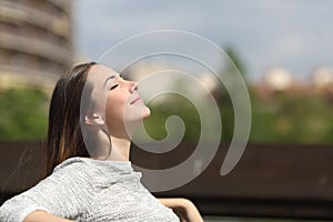 Urban woman breathing deep fresh air