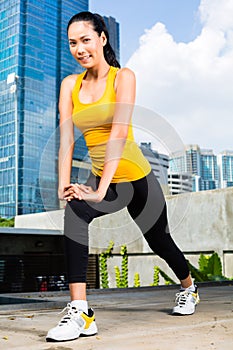 Urban woman sports - fitness in Asian city