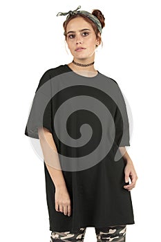 Urban woman street wear model in camo cargo`s and an oversized black t-shirt with copy-space