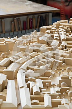 Urbanistic wooden model with tools in the background in the back